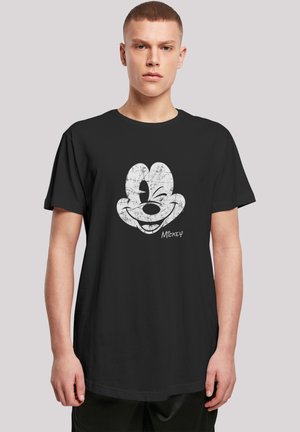 Black t-shirt featuring a large, distressed white graphic of a cartoon character's smiling face, with the name "Mickey" below the design.