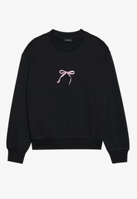 Svart sweatshirt laget av myk stoff, med en rosa brodert sløyfe på forsiden. Rund hals, lange ermer og ribbede mansjetter.
