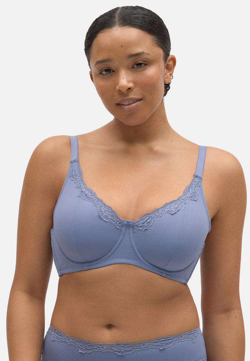 Sostén azul con detalle de encaje en el escote, confeccionado en tejido texturizado, con tirantes ajustables y un diseño estructurado para mayor soporte.