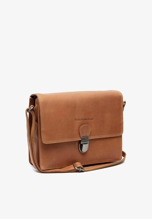 Brown leather messenger bag with front flap, metal buckle closure, adjustable shoulder strap, and embossed brand name "The Chesterfield Brand."