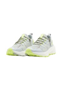 Athletic shoes with a light grey mesh upper, reflective accents, and bright yellow details. Thick white sole with a textured green rubber outsole.