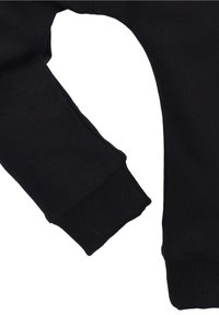 Schwarze Sweatpants mit gerippten Bündchen und einem glatten, strukturierten Stoff. Sie haben eine lockere Passform und ein minimalistisches Design, das den Fokus auf Komfort legt.