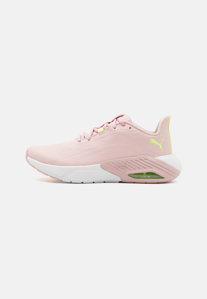 Pink athletic shoes with a smooth upper, white sole, green accent, and perforated detailing. Features a cushioned heel and lace-up design.