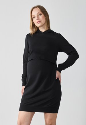 Zwart sweatshirtjurk met een cropped top en lange mouwen. Gemaakt van zachte stof, met een capuchon en ribgebreide manchetten en zoom.