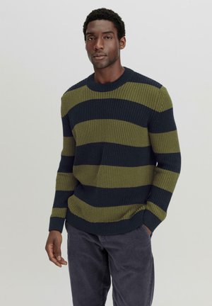 Knit sweater featuring green and navy horizontal stripes, crew neck, ribbed cuffs, and a relaxed fit. Pairing with dark corduroy pants.