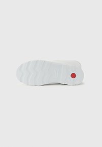 White sneaker sole with a textured, zigzag pattern. Features a red circular logo and subtle branding. Made of rubber material.