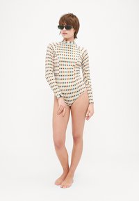 Long-sleeve swimsuit featuring a multicolored grid pattern on a light background, made from stretchy material, with a high neck design.
