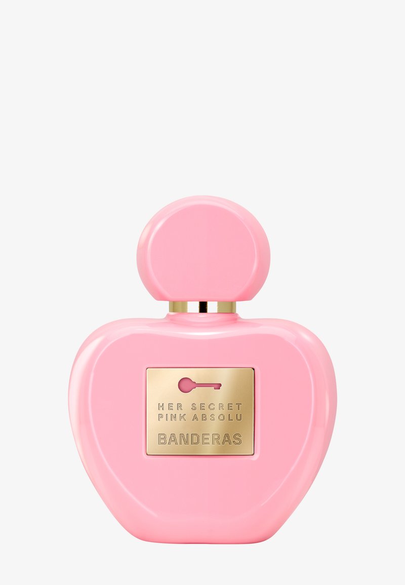 Roze hartvormige parfumfles met een ronde dop en een gouden label met de tekst "Her Secret Pink Absolu Banderas."