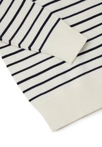 White sweater with navy horizontal stripes, ribbed cuffs and hem, knitted texture, angled view highlighting sleeve and side detail.