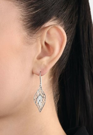 Silberne, blattförmige Ohrringe mit einem durchbrochenen Design, die eine glänzende, glatte Oberfläche und einen Hakenverschluss haben, der nah am Ohr hängt.