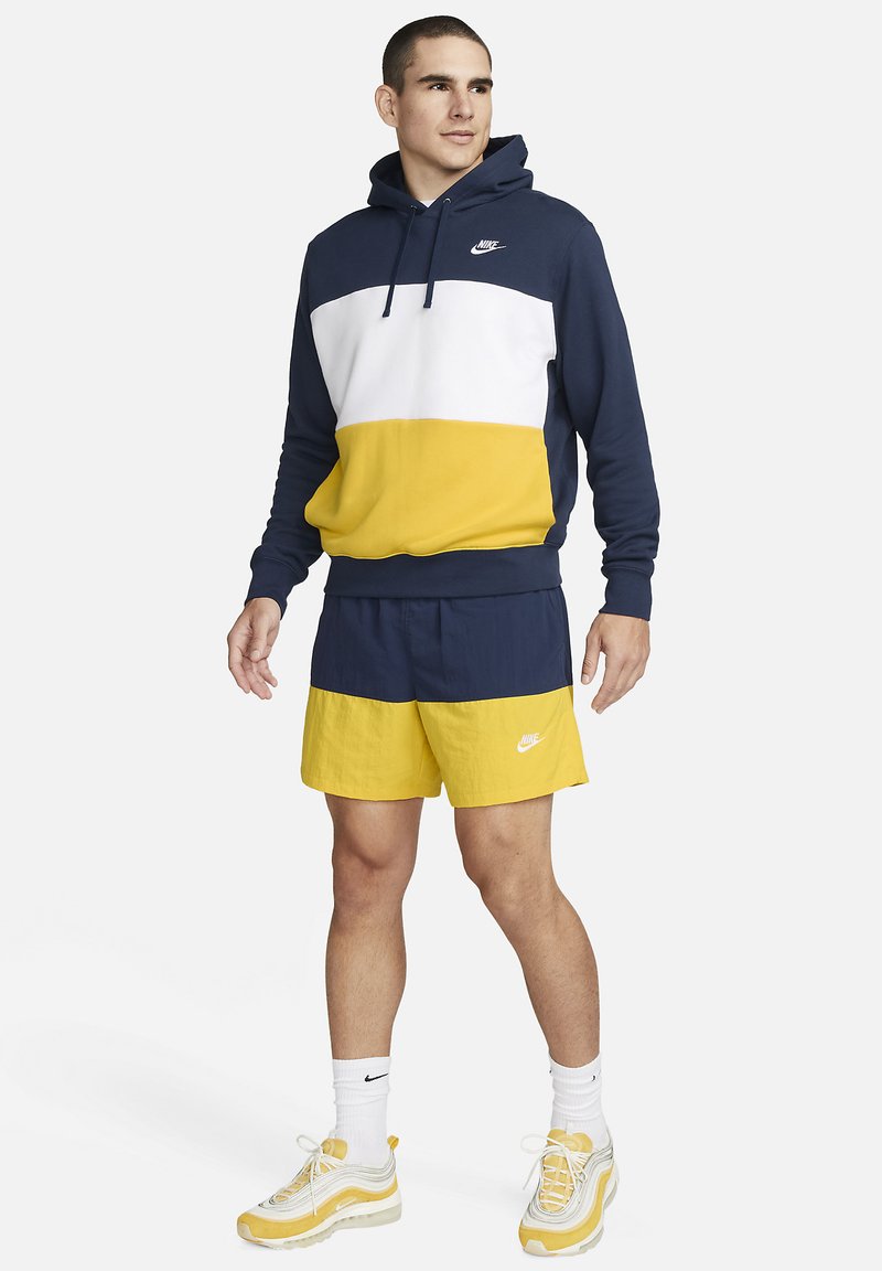 Nike Sportswear M CLUB WVN CB - Tracksuit bottoms - midnight navy  vivid/sulphur white/dark blue - Zalando.de