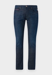 Jean en denim bleu foncé à coupe slim avec une légère décoloration, fermeture à bouton, passants de ceinture, et design classique à cinq poches sur fond blanc.