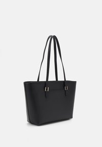 Black tote bag made of smooth synthetic material, featuring two long handles, a square shape, and gold-tone hardware accents.