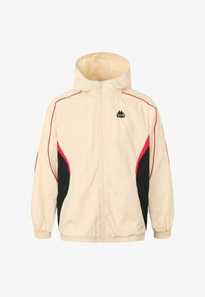 Kremasti hooded jakna s crvenim i crnim detaljima, s patentnim zatvaračem sprijeda, elastičnim rukavima i bočnim panelima za sportski dizajn. Prikazan logo Kappa.