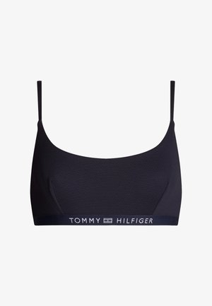 Tamnoplava bralette s teksturiranom tkaninom, podesivim trakama i trakom s bijelim logotipom "TOMMY HILFIGER". Bežični dizajn za udobnost.
