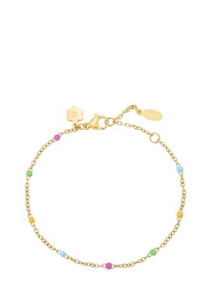 Delicate gold chain bracelet with small colorful beads worn on wrist, paired with layered gold necklaces and white clothing.