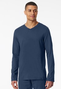 T-shirt a maniche lunghe blu navy con scollo a V, realizzato in tessuto morbido. Presenta una superficie liscia e una vestibilità comoda. Adatto per l'abbigliamento casual.