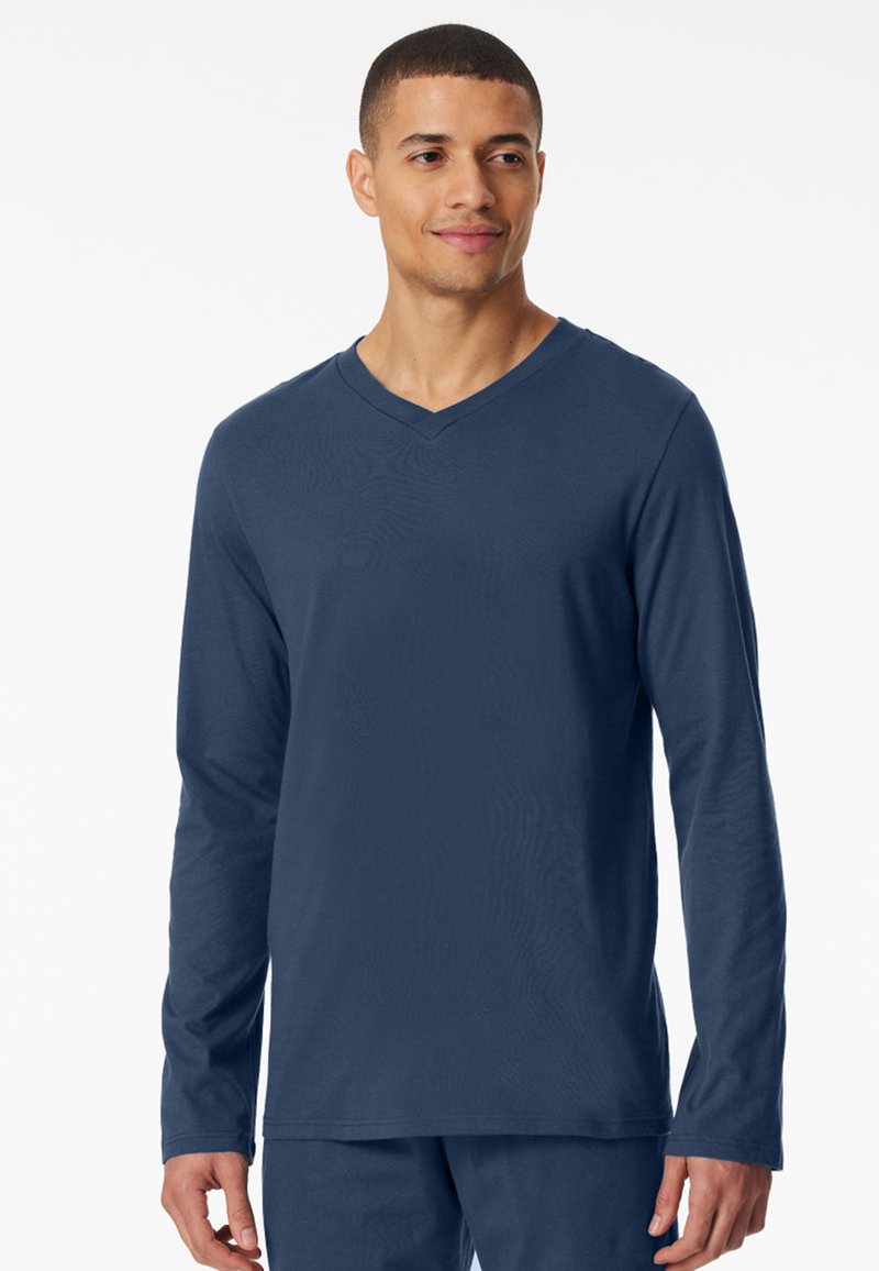T-shirt a maniche lunghe blu navy con scollo a V, realizzato in tessuto morbido. Presenta una superficie liscia e una vestibilità comoda. Adatto per l'abbigliamento casual.