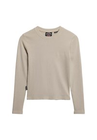 Beige langærmet ribstrikket skjorte med rund hals og subtilt logo på brystet. Har en lige kant og et mærke på sidesømmen.