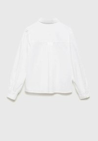 White long-sleeve shirt with a button-up collar, smooth texture, and pleated back detail. Cuffed sleeves feature button accents.