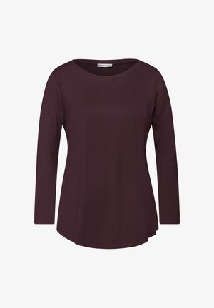 Camiseta de manga larga en púrpura oscuro, hecha de una tela suave. Cuenta con un escote redondeado y un ajuste relajado con un dobladillo ligeramente acampanado.