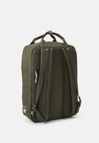 Dark green backpack made of fabric with a smooth texture. Features padded straps, a top handle, and side zipper pockets. Mesh accents included.