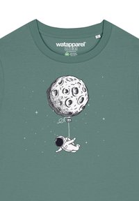 Groen katoen t-shirt met een astronaut die een ballon vasthoudt; de ballon is een gedetailleerde illustratie van de maan, omringd door sterren.