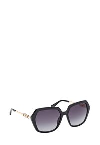 Zwarte oversized zonnebril met hoekige monturen, gradueel getinte glazen en goudkleurige metalen accenten op de pootjes. Gladde, glanzende afwerking.