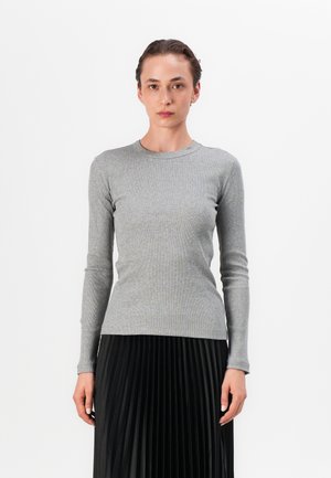 Gray long-sleeve ribbed top featuring a crew neckline, paired with a black pleated skirt, highlighting the top's soft texture and fitted design.