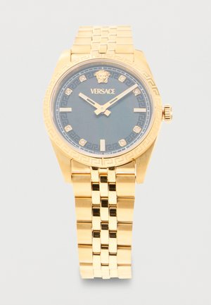 Montre-bracelet Versace dorée avec cadran noir, logo Méduse à 12 heures, index des heures en diamant et bracelet métallique maillé.