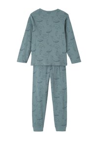 Long-sleeve blue-gray children's pajamas with ribbed texture and outline animal patterns including whales, polar bears, and penguins.