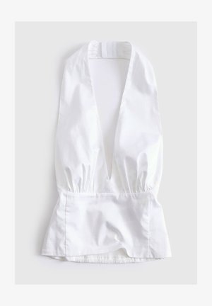 Witte mouwloze blouse met diepe V-hals, gerimpelde taille en peplumzoom, plat gelegd op een lichte achtergrond.