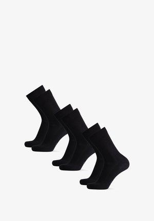 Chaussettes en coton noir, ensemble de cinq, avec une bordure côtelée, une texture lisse et un design classique de longueur crew. Sans motifs ni accents.