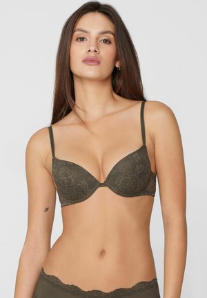 Reggiseno in pizzo verde con coppe imbottite, spalline sottili regolabili, motivo floreale e design senza cuciture. Dotato di ferretto per sostegno e modellatura.