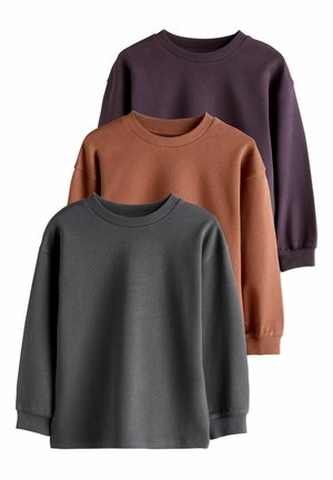 Three long-sleeve sweatshirts in dark gray, rust, and dark purple. Each features a crew neckline and ribbed cuffs. Soft fabric texture.