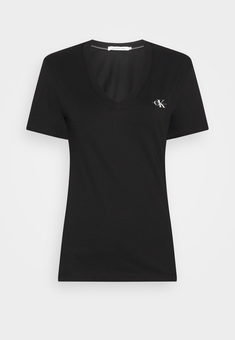 Black cotton t-shirt with a V-neck and short sleeves. Features a small white "CK" logo on the left chest. Smooth texture, classic fit.
