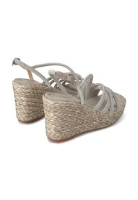 Sandali con zeppa beige con suole in juta intrecciata, cinturini metallici decorativi e soletta imbottita. Cinghia alla caviglia regolabile per una vestibilità ottimale.