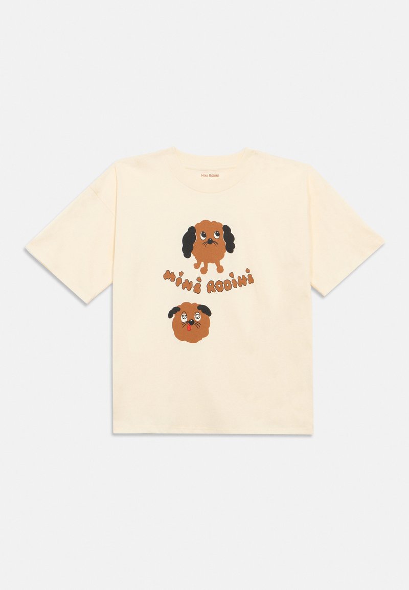 T-shirt de cor creme com duas caras de cães de desenho animado castanho, uma de pé e outra com a língua de fora, e o texto "Mini Rodini" entre elas.