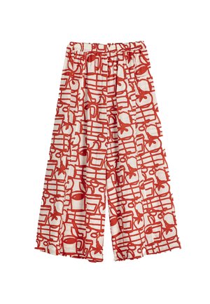 Pantalon à jambes larges avec une taille élastique, présentant un motif abstrait rouge vif sur un tissu blanc.