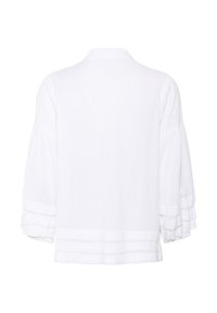 Blusa bianca, texturizzata, a maniche lunghe con polsini arricciati e dettaglio a strisce orizzontali lungo l'orlo. Tessuto morbido e leggero.