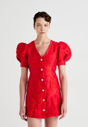 Red puff-sleeve dress in textured fabric, with a deep V-neck and five large button closures. Floral pattern embossed throughout.