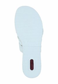 White rubber sandal sole with horizontal grooves, a rounded toe, and a logo in red situated in an oval cutout near the heel.