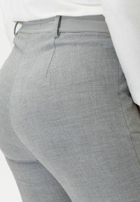 Gray tailored pants with a textured fabric, slim fit, and a smooth waistband, featuring subtle stitching details.