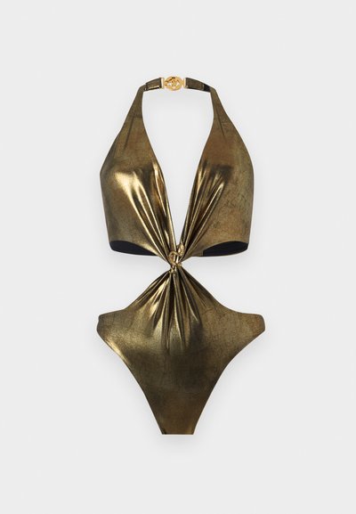 Maillot de bain une pièce en or métallique avec un col halter, détail de nœud à l'avant et une boucle ronde en or au niveau du cou.