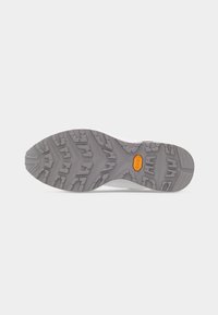 Semelle de chaussure grise avec des motifs de traction profonds et un logo Vibram orange au centre sur un fond blanc.