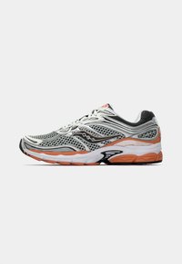 Athletic shoes featuring a breathable mesh upper in gray and black, with orange accents on the sole and a curved heel design.