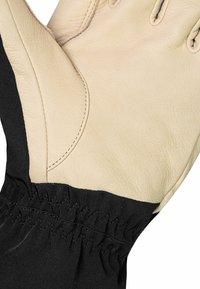 Leren handschoen met een tan palm en een zwarte stoffen boord. De boord heeft gathered elastische stiksels voor een veilige pasvorm. Soepele textuur.