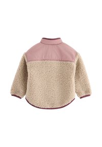 Miękka beżowa warstwa zewnętrzna z różową górną częścią i kołnierzem. Posiada długie rękawy i zaokrąglony dół. Teksturowana tkanina.