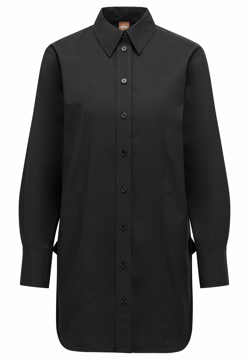 Black long-sleeve shirt featuring a pointed collar, front button closure, subtle tonal stitching, and side slits for ease of movement.