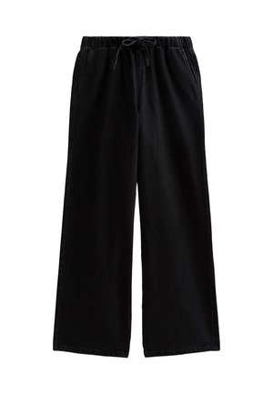 Pantalones anchos negros de algodón suave con cinturilla elástica y cordón, que cuentan con bolsillos laterales y una textura simple y lisa.